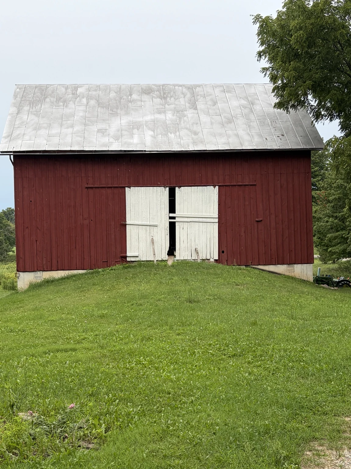 The real red barn beneath a broad Michigan sky